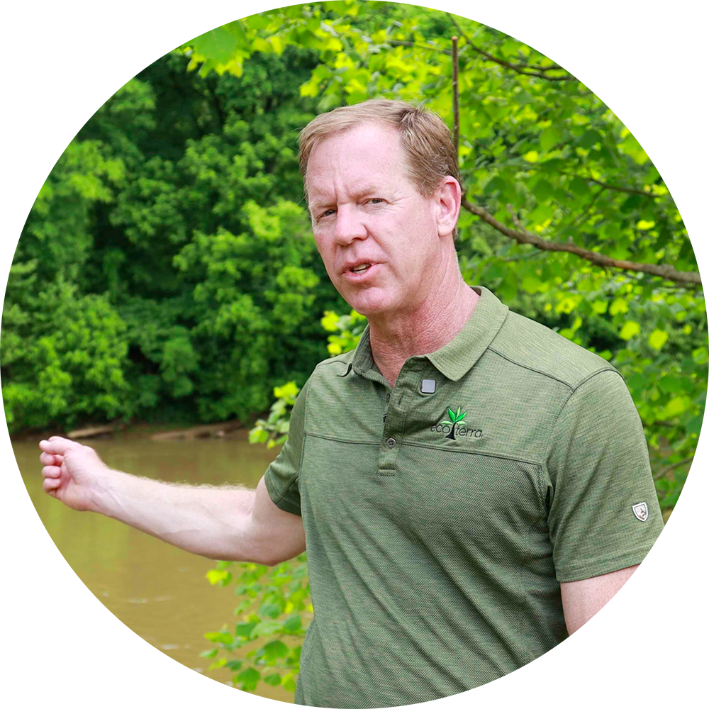 Image of Norton pointing at the Dan River during our Stream Restoration Video for Eco Terra at Mushroom Meadow Stream and Wetlands Mitigation Site in Milton, North Carolina